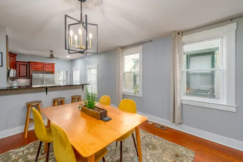 a view of a dining room with furniture and chandelier