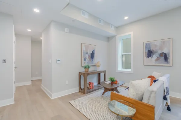 a living room with furniture and a wooden floor