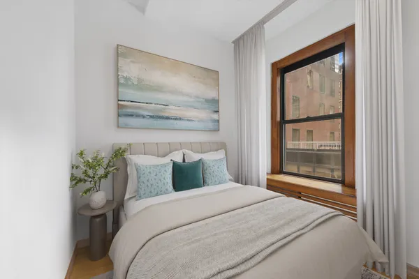 a bedroom with a bed and a painting on the wall