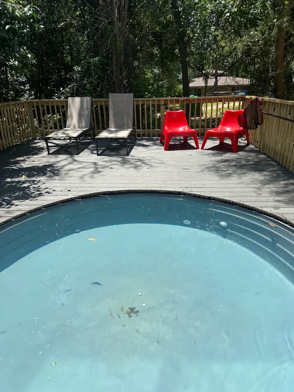a view of a wooden deck and a backyard