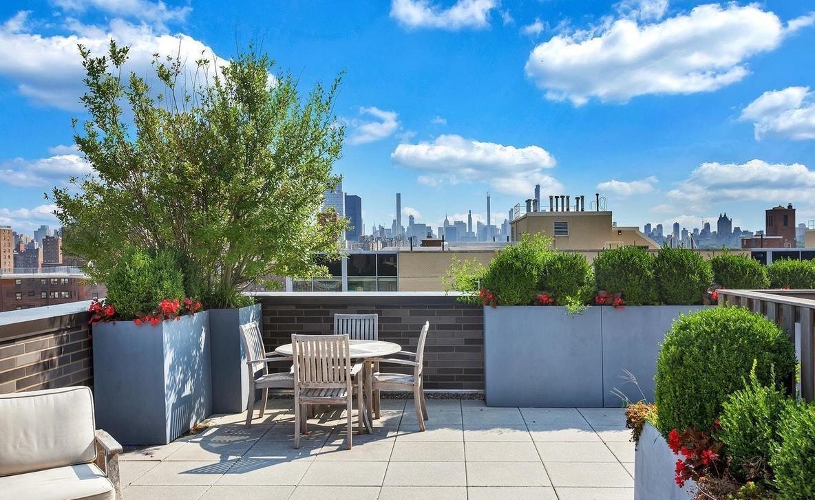 23 West 116th Street, Unit 8A Manhattan, NY 10026 - Photo 19 of 28 a view of a patio with table and chairs potted plants and a palm tree