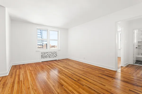 a view of an empty room and wooden floor