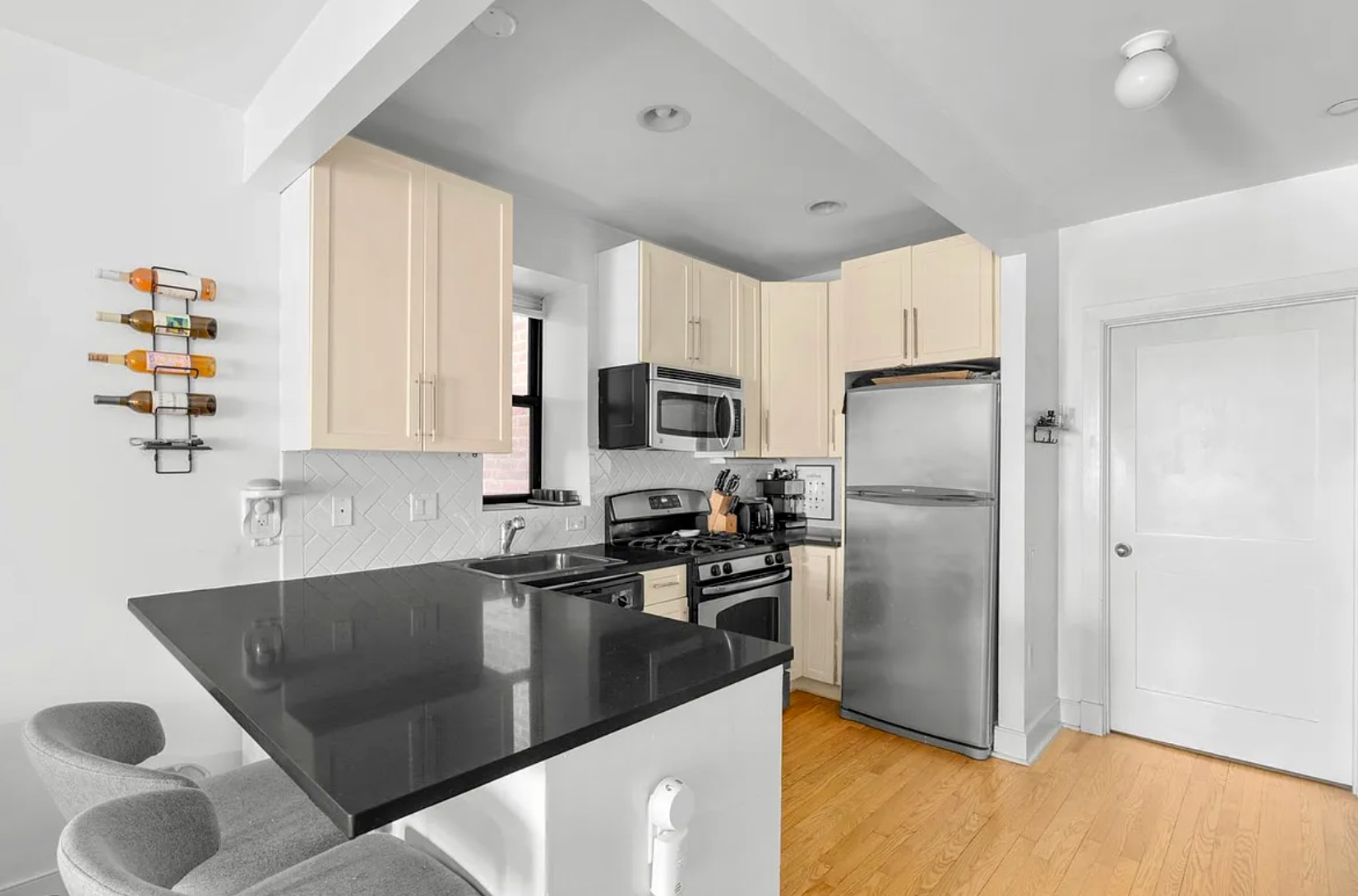 305 West 150th Street, Unit 203 Manhattan, NY 10039 - Photo 2 of 6 a kitchen with stainless steel appliances granite countertop a sink a stove and a refrigerator
