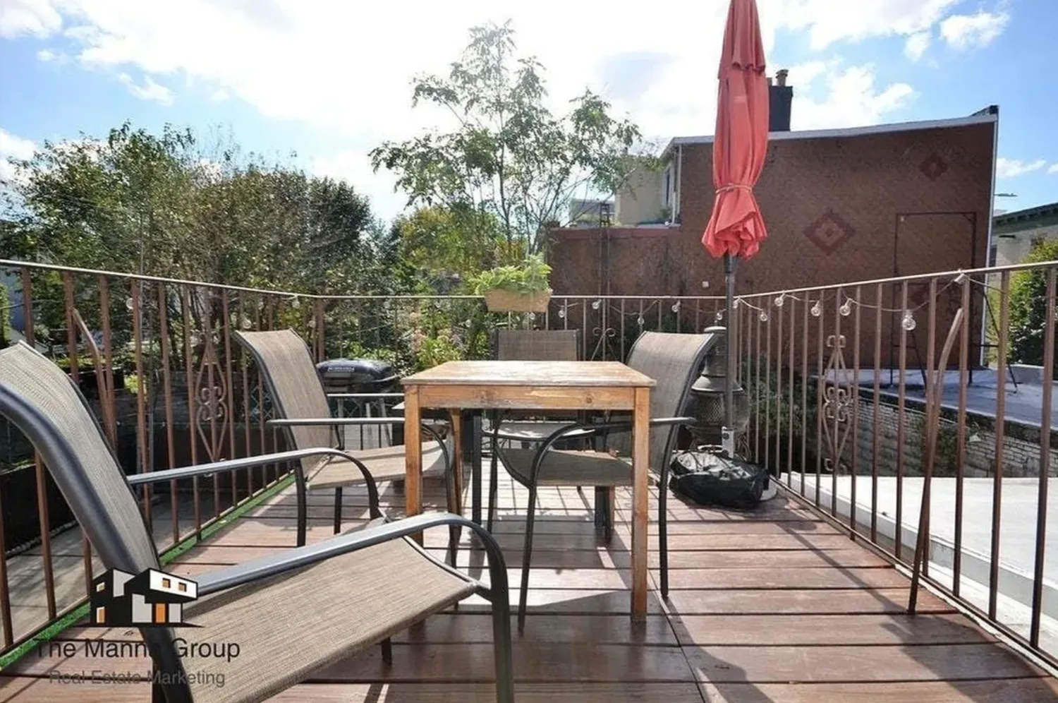 a view of a roof deck with table and chairs