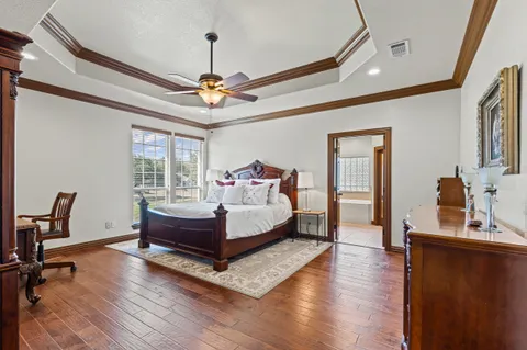 a large bedroom with bed and a chandelier