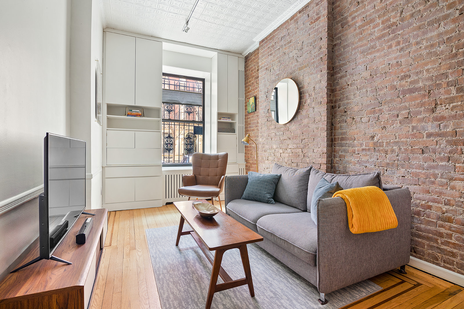 a living room with furniture and a wooden floor