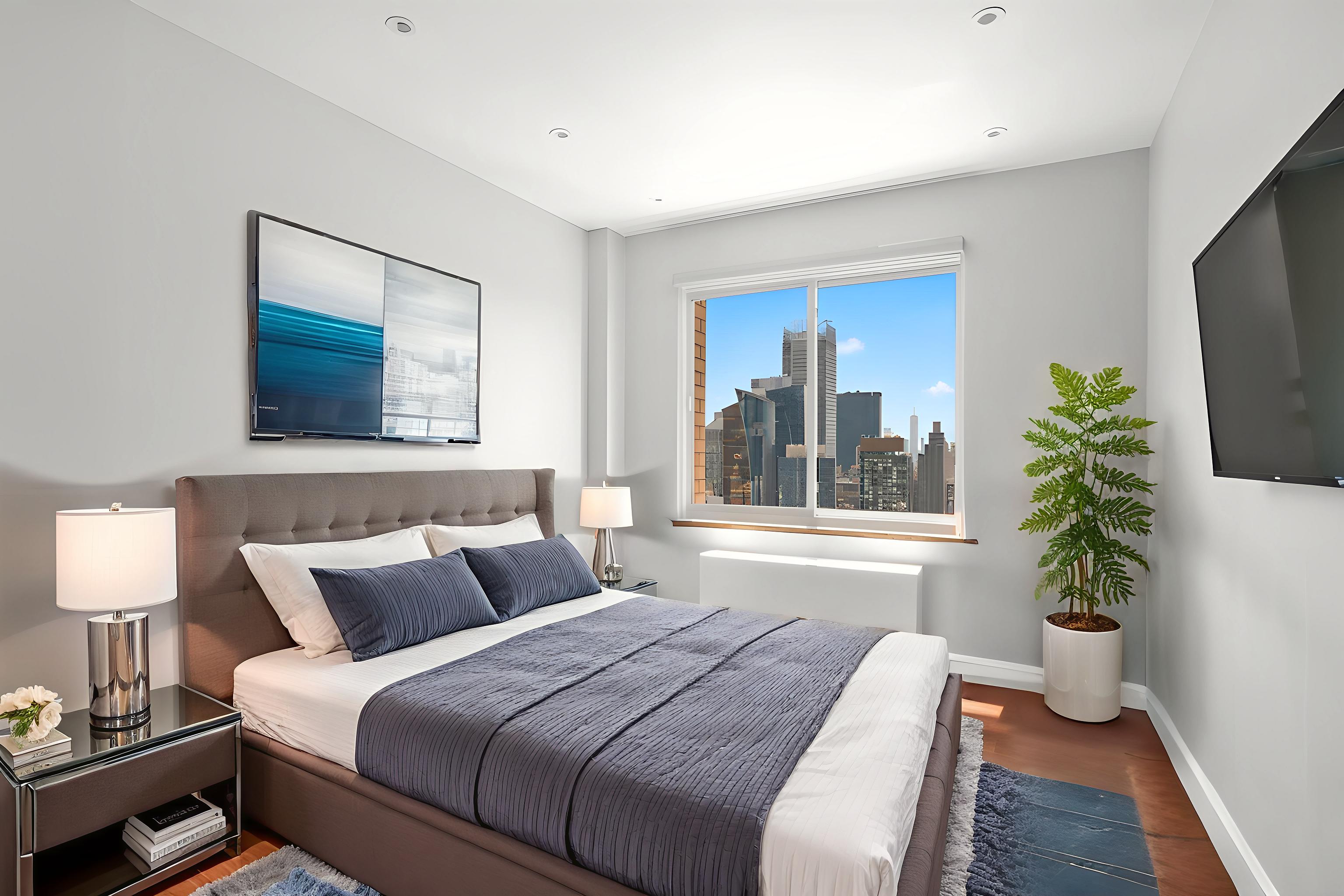 350 West 50th Street, Unit PH4B Manhattan, NY 10019 - Photo 7 of 18 a bedroom with bed and a potted plant