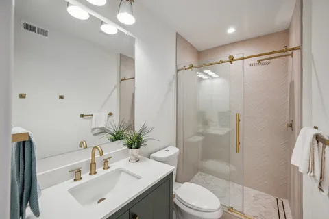 a bathroom with a shower and a glass door