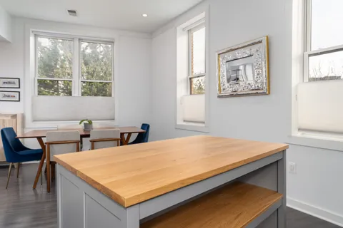 a room with pool table and windows