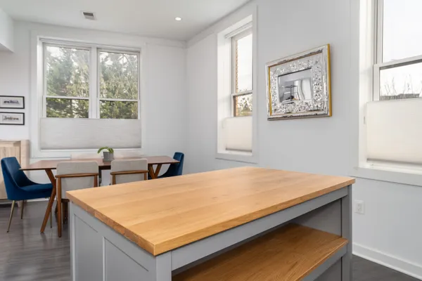 a room with pool table and windows