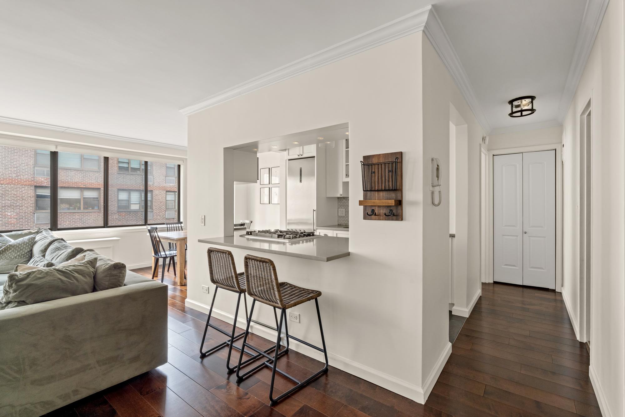 345 East 73rd Street, Unit 11KL Manhattan, NY 10021 - Photo 4 of 12 a living room with furniture and a table