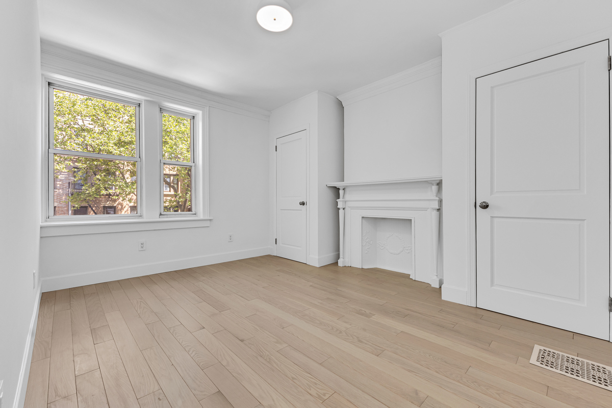 1050 Sterling Place Brooklyn, NY 11213 - Photo 20 of 23 a view of empty room with wooden floor and fan