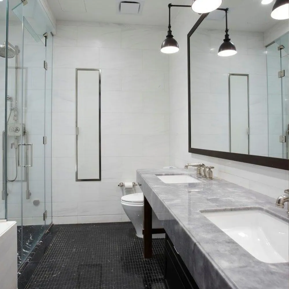 a bathroom with a granite countertop sink a toilet and shower