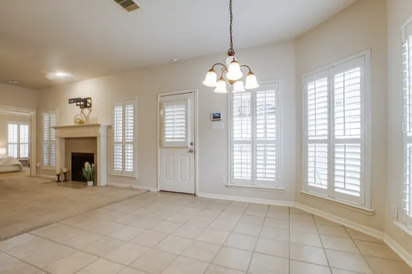 a large kitchen with a fireplace and a chandelier