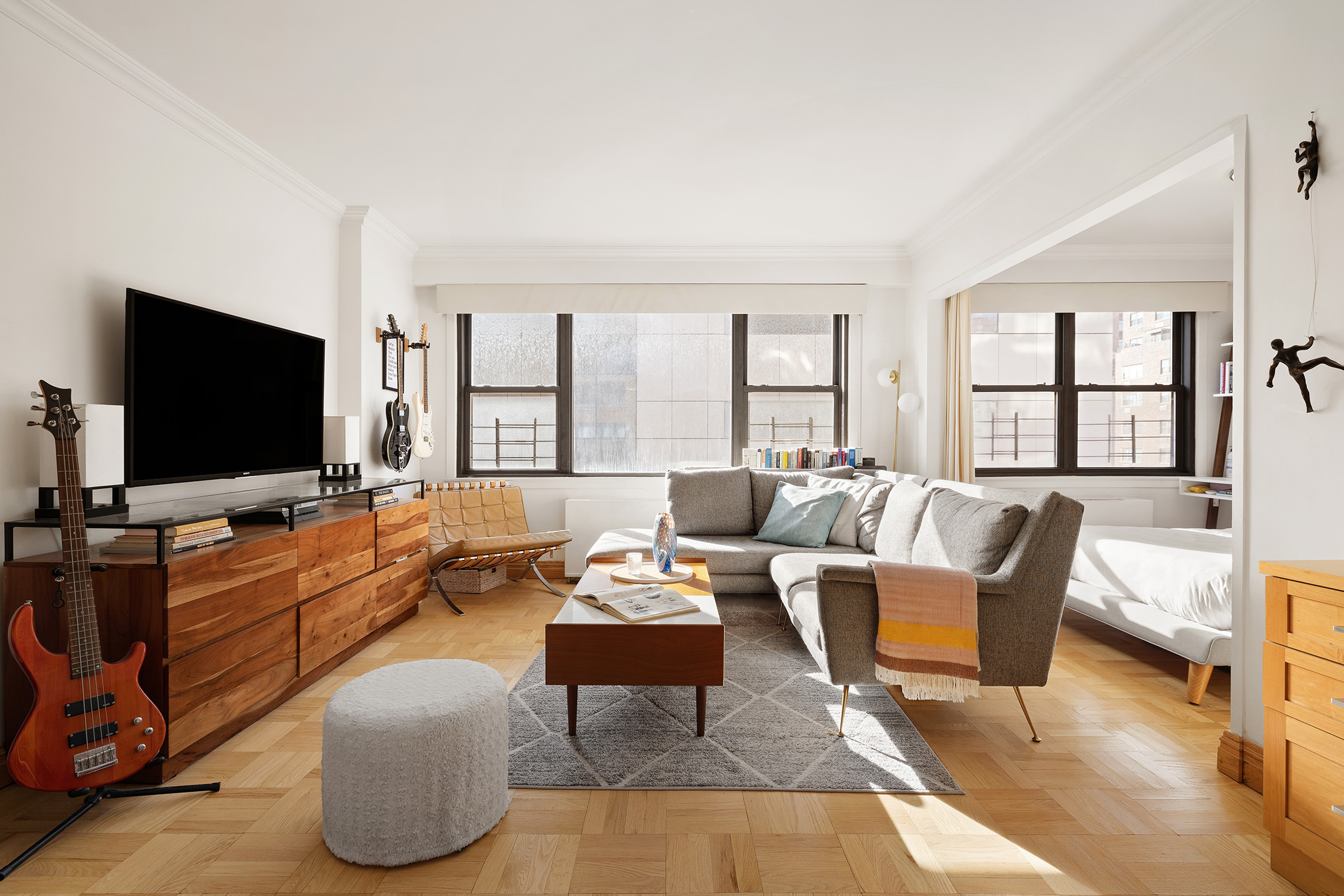 201 East 77th Street, Unit 11E Manhattan, NY 10075 - Photo 1 of 7 a living room with furniture and a flat screen tv