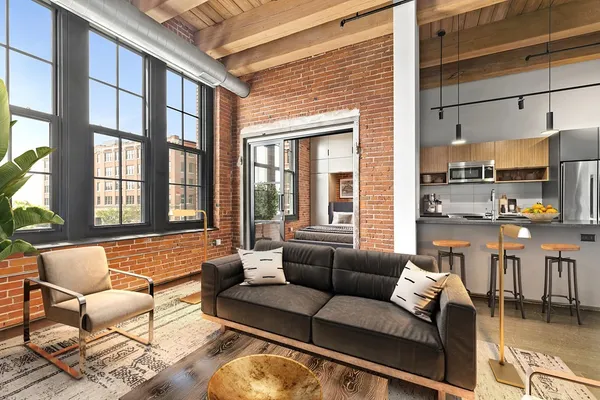 a living room with furniture and a large window