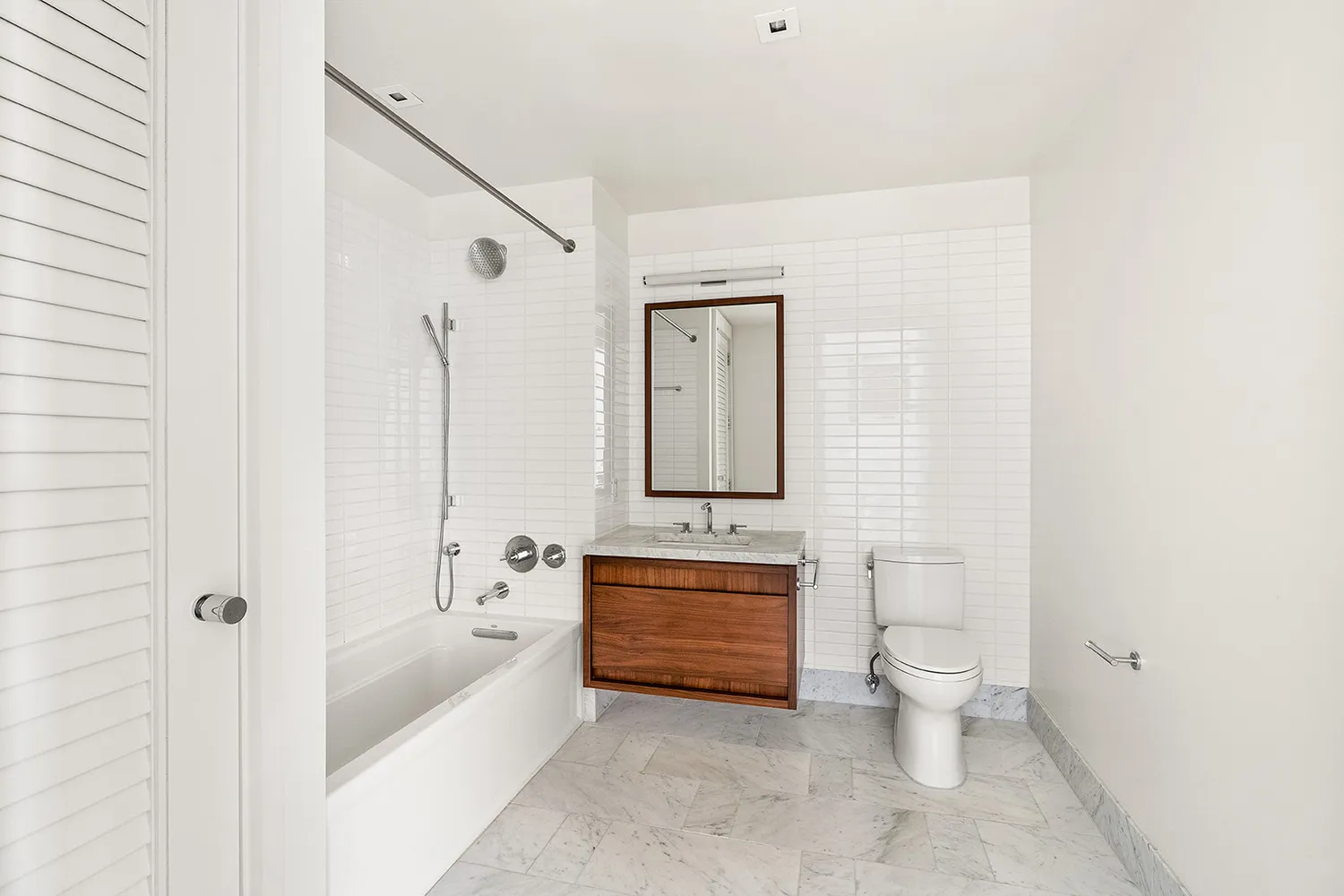 a spacious bathroom with a toilet a sink and a bathtub