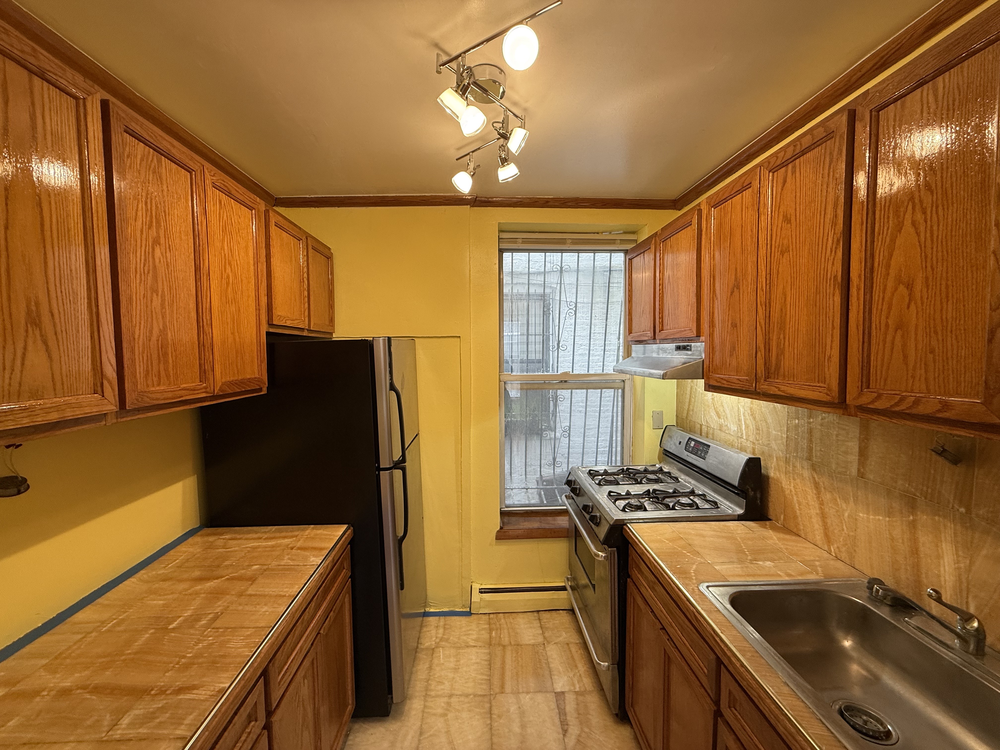 a kitchen with stainless steel appliances granite countertop a sink refrigerator and microwave