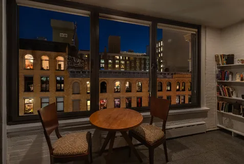 a view of a dining room with furniture and window