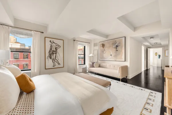 a bathroom with a white tub a sink and a large mirror