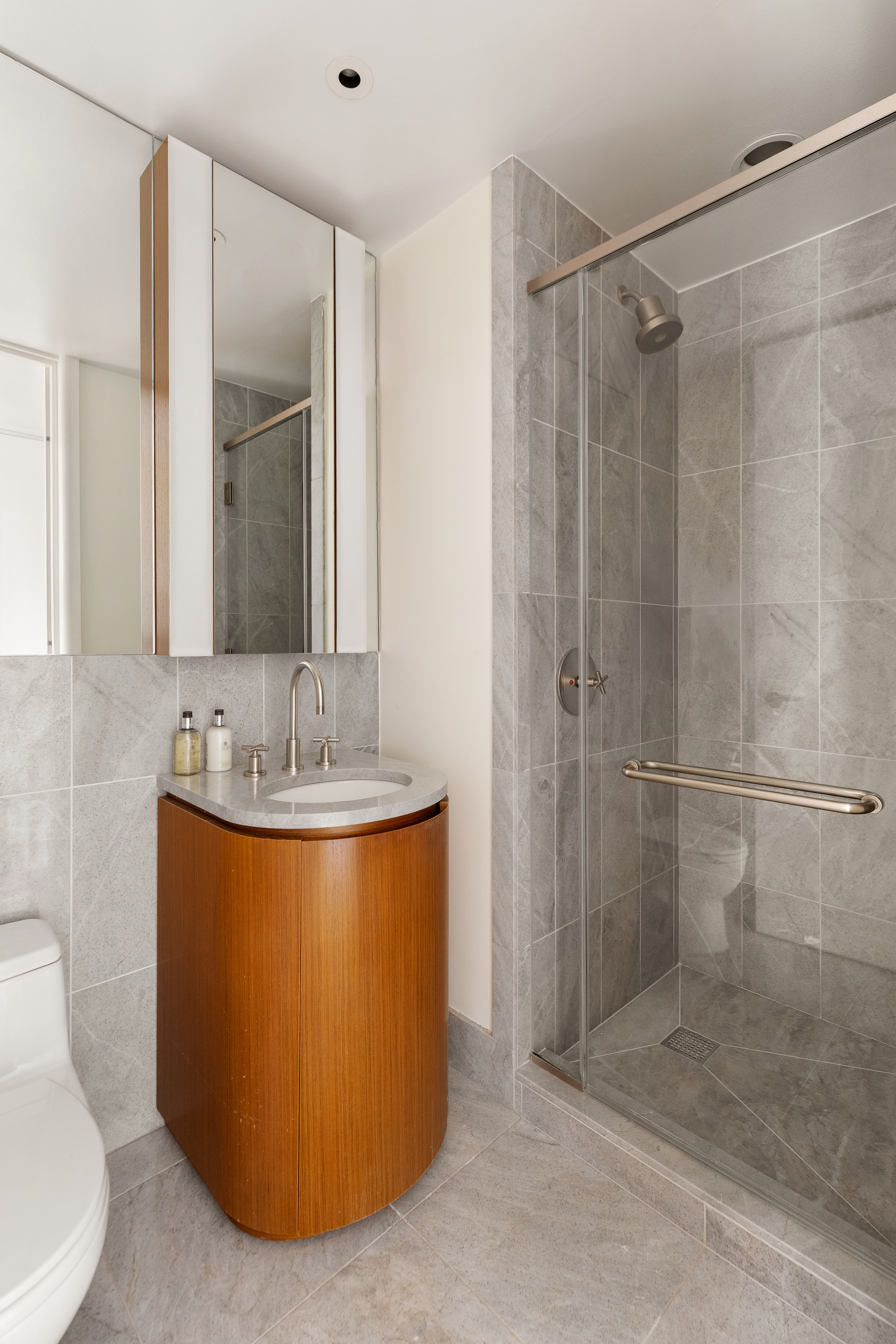50 United Nations Plaza, Unit 6B Manhattan, NY 10017 - Photo 11 of 13 a bathroom with a sink toilet and shower