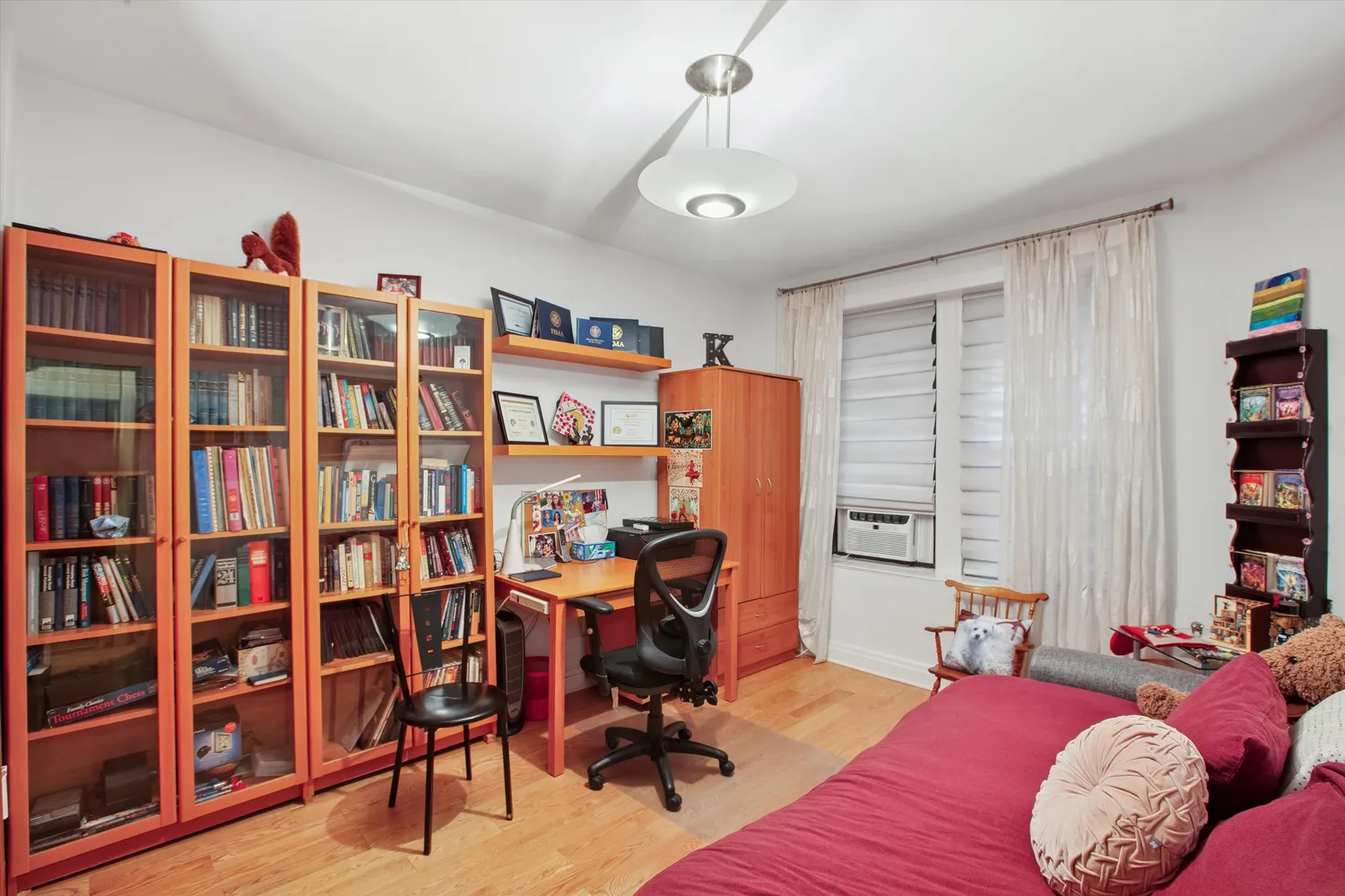 a view of a livingroom with workspace and a window