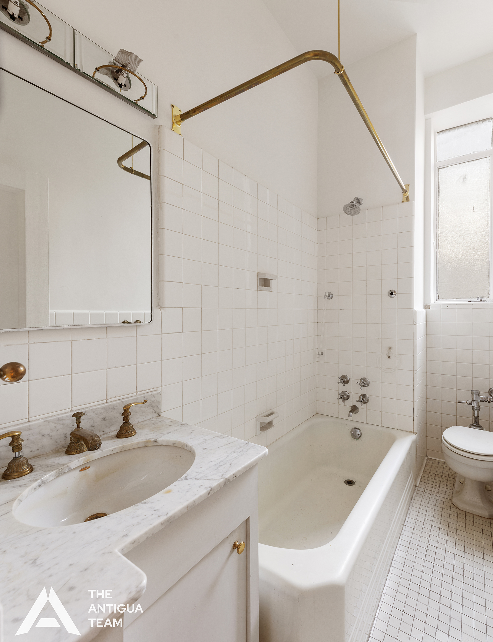 45 East 66th Street, Unit 4N Manhattan, NY 10065 - Photo 5 of 10 a bathroom with a sink a toilet and shower