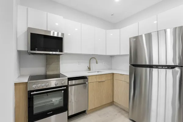 a kitchen with a sink and a stove top oven