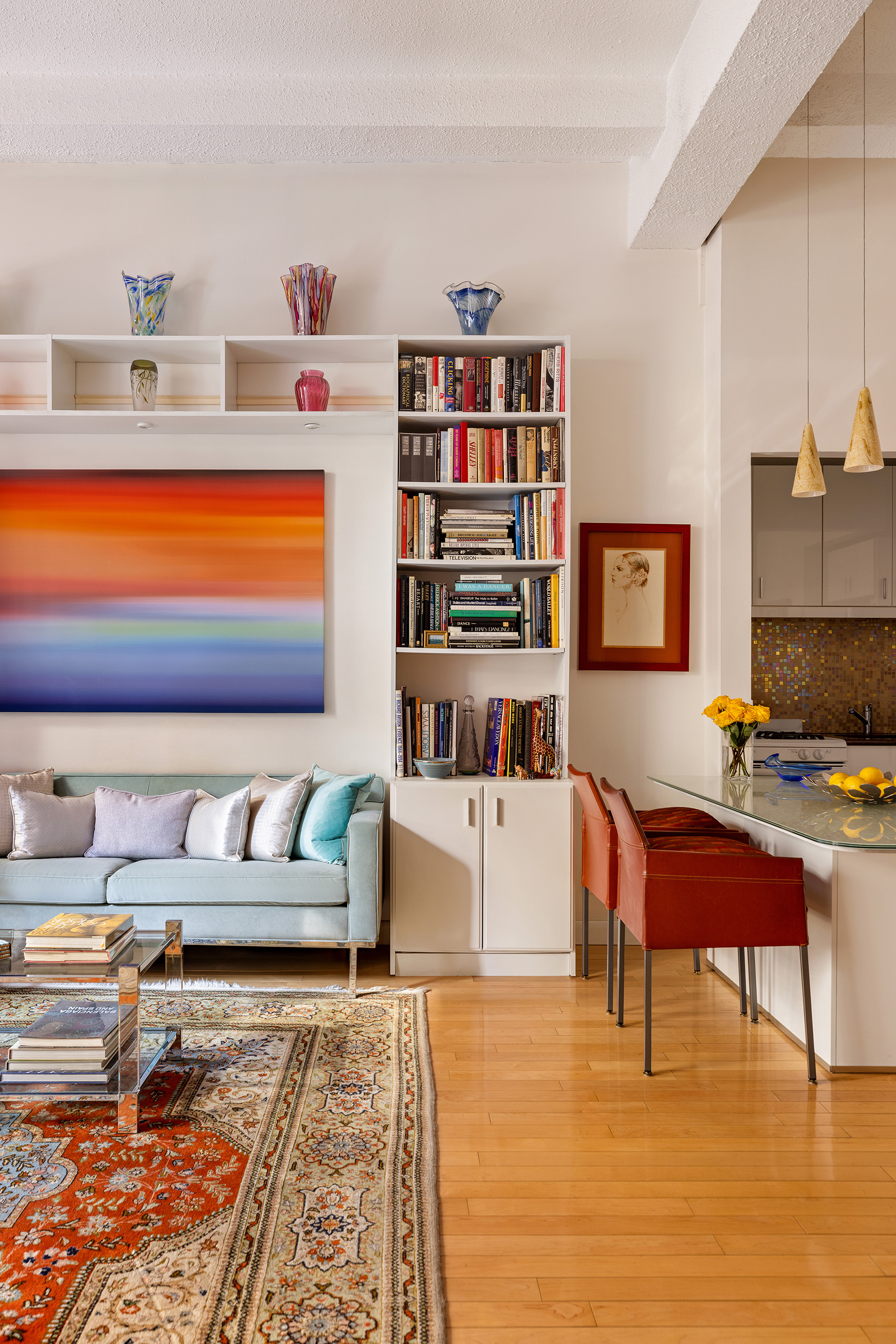 21 East 22nd Street, Unit 2K Manhattan, NY 10010 - Photo 3 of 13 a living room with furniture and a book shelf