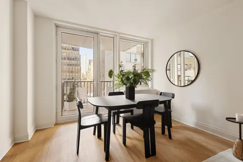 a view of a dining room with furniture and a potted plant