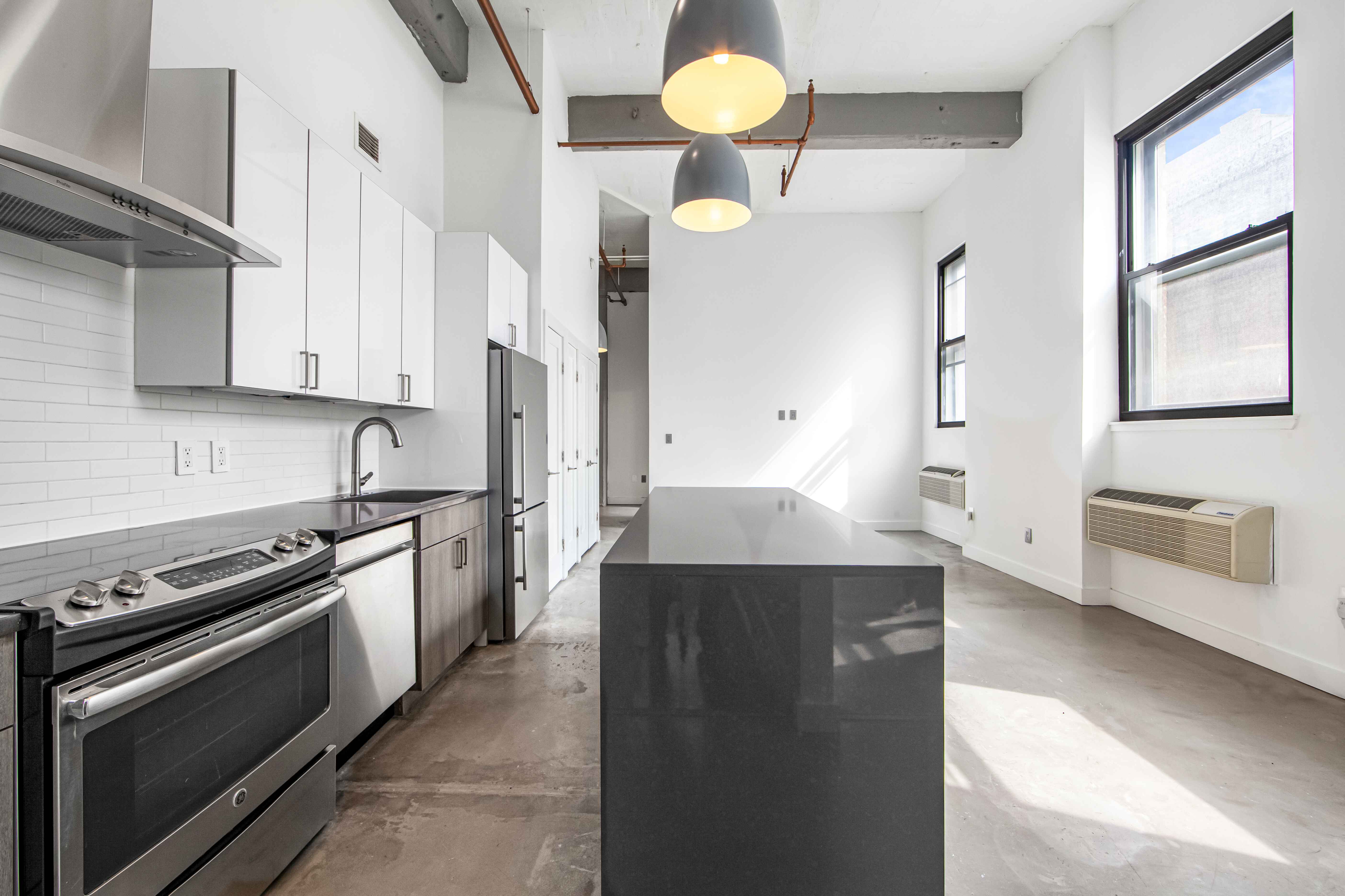 44 Berry Street, Unit 2K Brooklyn, NY 11249 - Photo 3 of 6 a kitchen with stainless steel appliances a stove a sink and a refrigerator