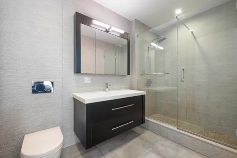 a bathroom with a sink toilet and shower