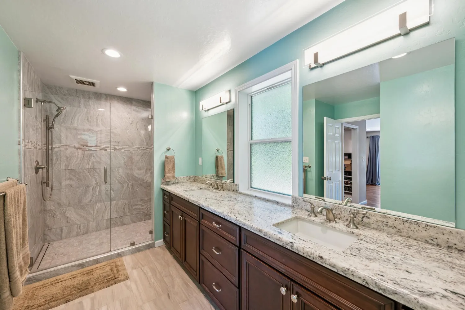 a view of a lake with houses in the background