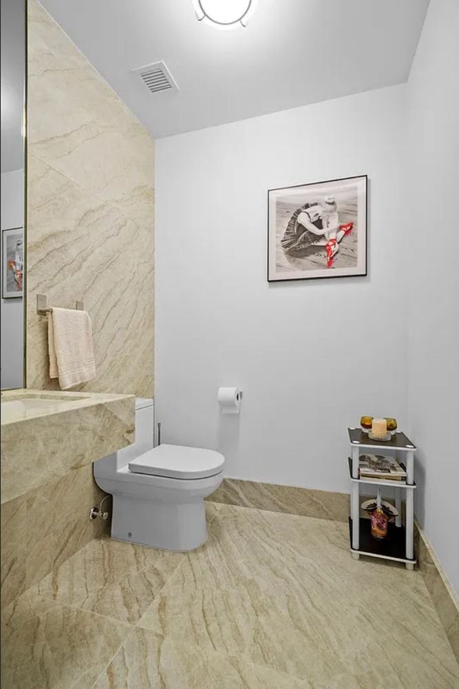15 Hudson Yards, Unit 28J Manhattan, NY 10001 - Photo 5 of 5 a bathroom with a toilet a sink and a shower