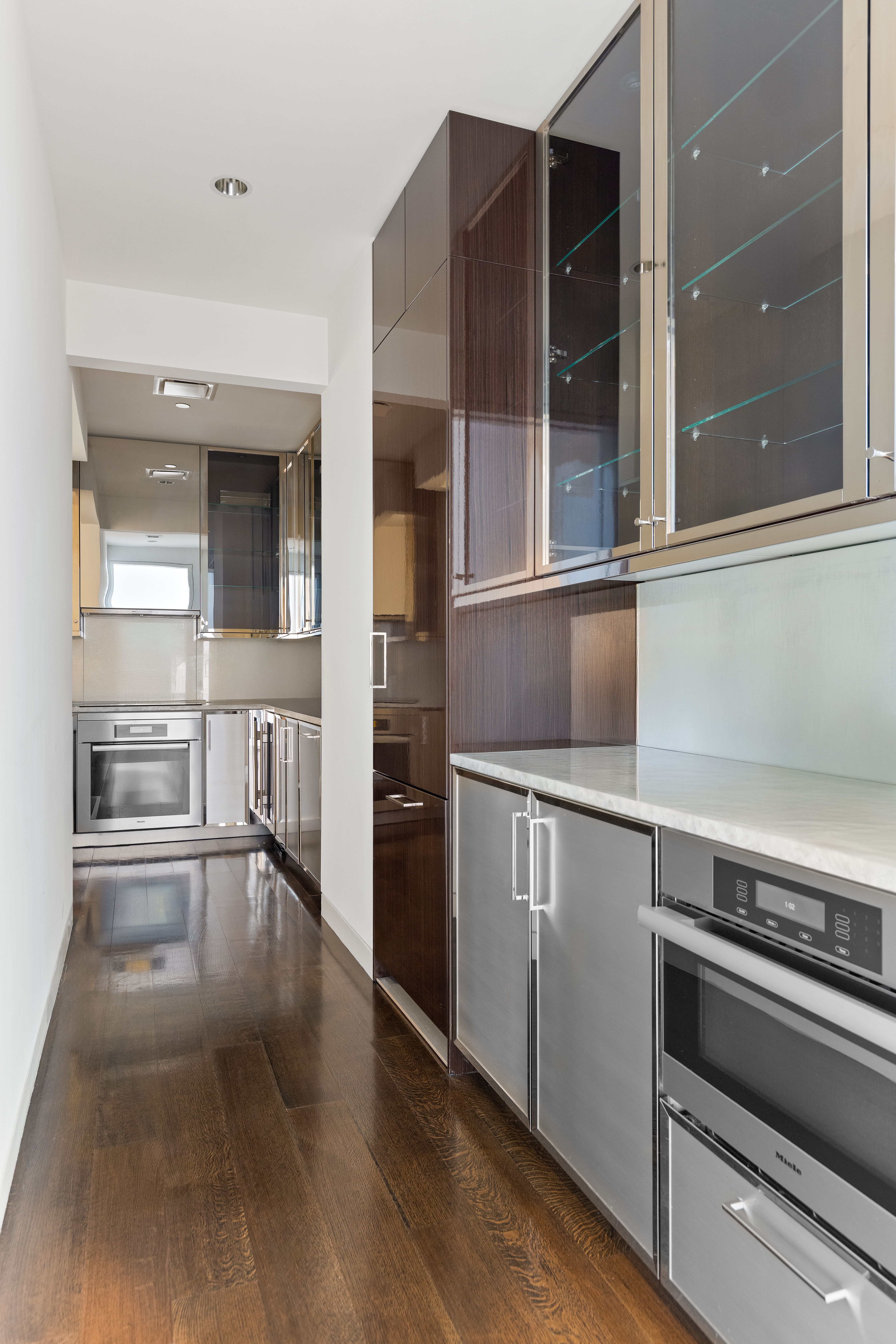 20 West 53rd Street, Unit 22A Manhattan, NY 10019 - Photo 5 of 16 a kitchen with granite countertop a oven and cabinets