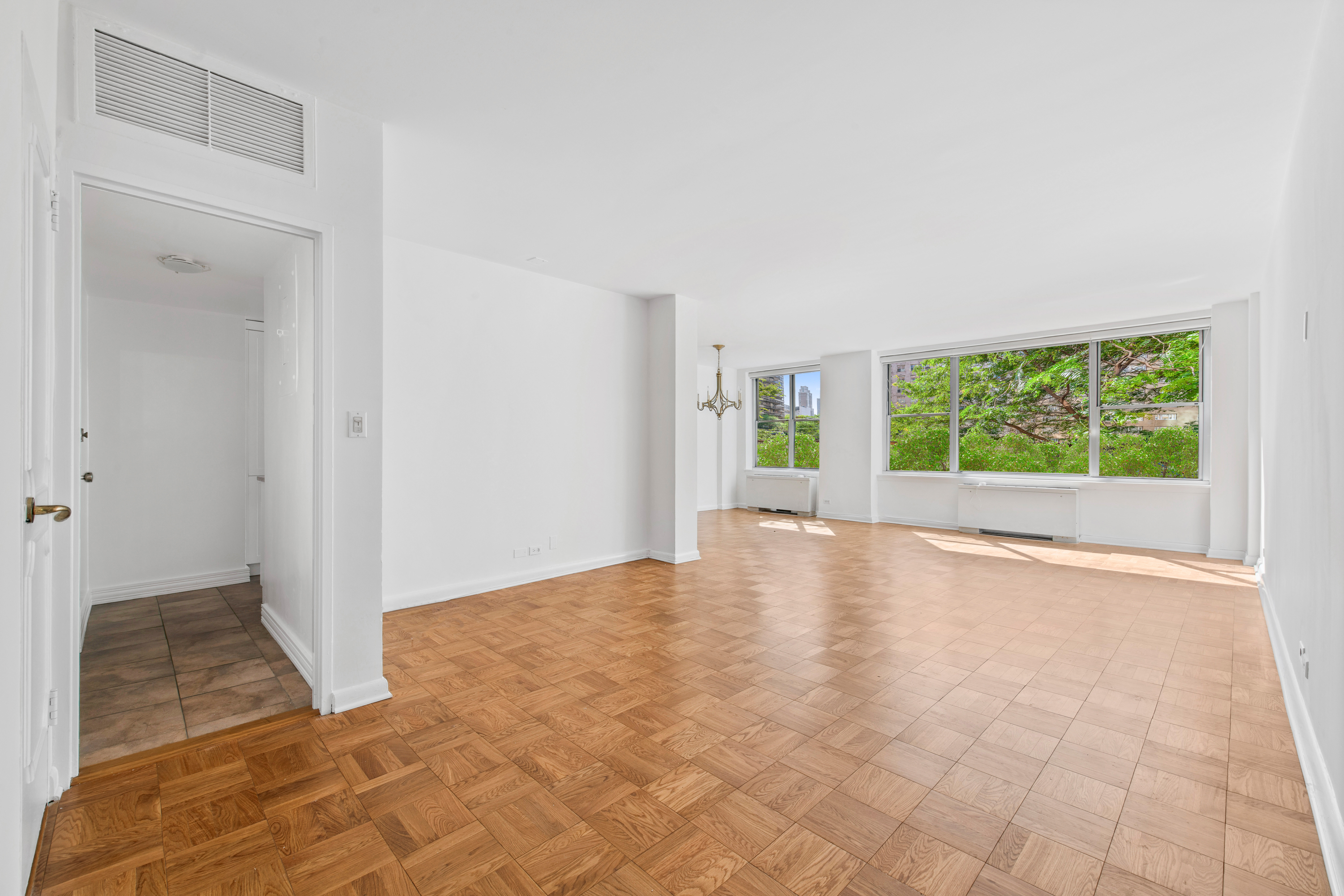 201 East 62nd Street, Unit 2C Manhattan, NY 10065 - Photo 6 of 14 a view of an empty room with a window