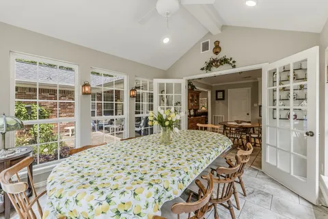 a large dining space with furniture window and wooden floor