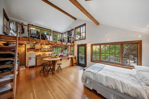 a open kitchen with stainless steel appliances a stove and a large window