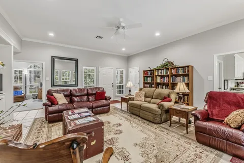 a living room with furniture and a chandelier