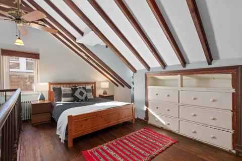 a bedroom with a bed and a mirror