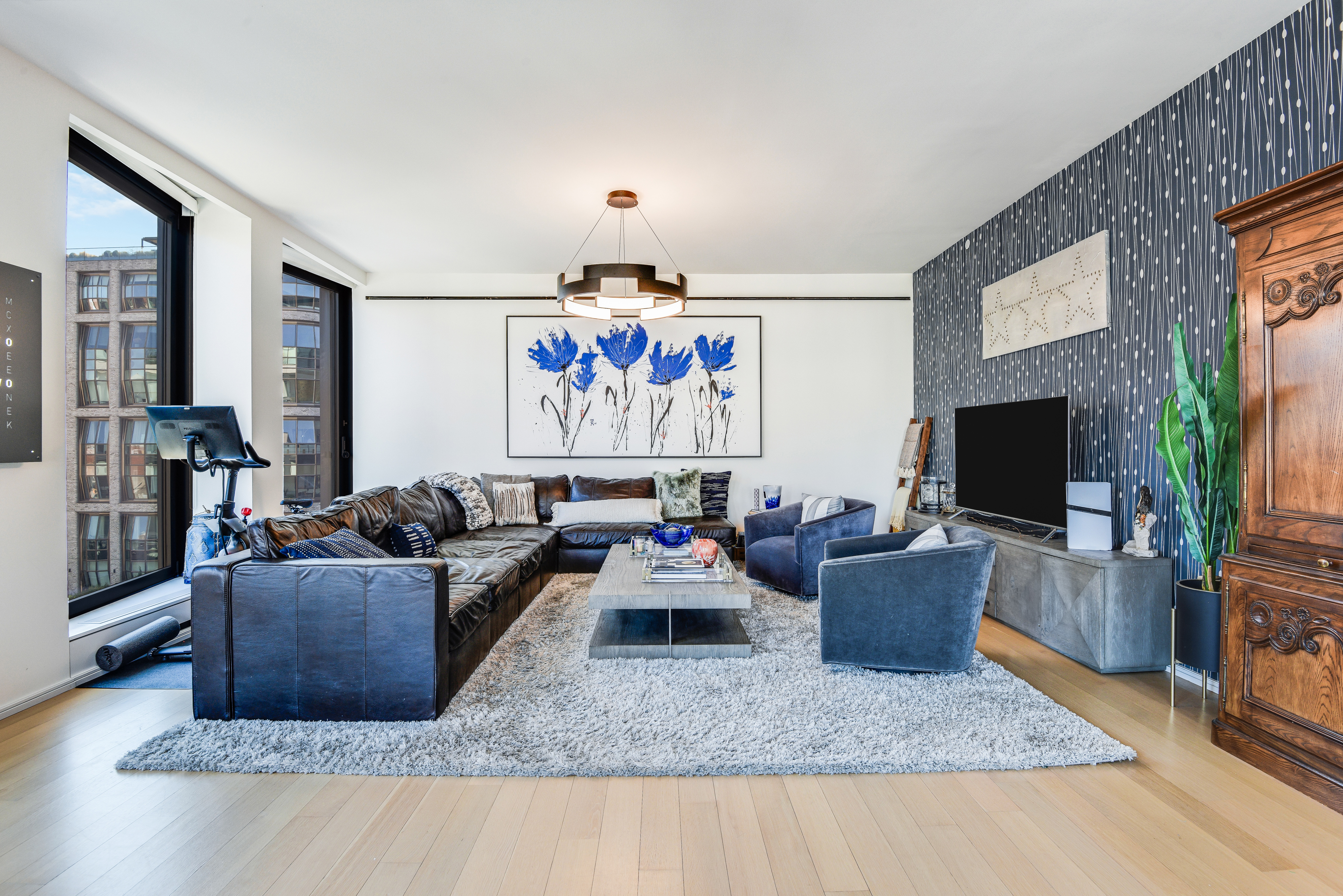 505 West 19th Street, Unit 7W Manhattan, NY 10011 - Photo 3 of 31 a living room with furniture and a flat screen tv