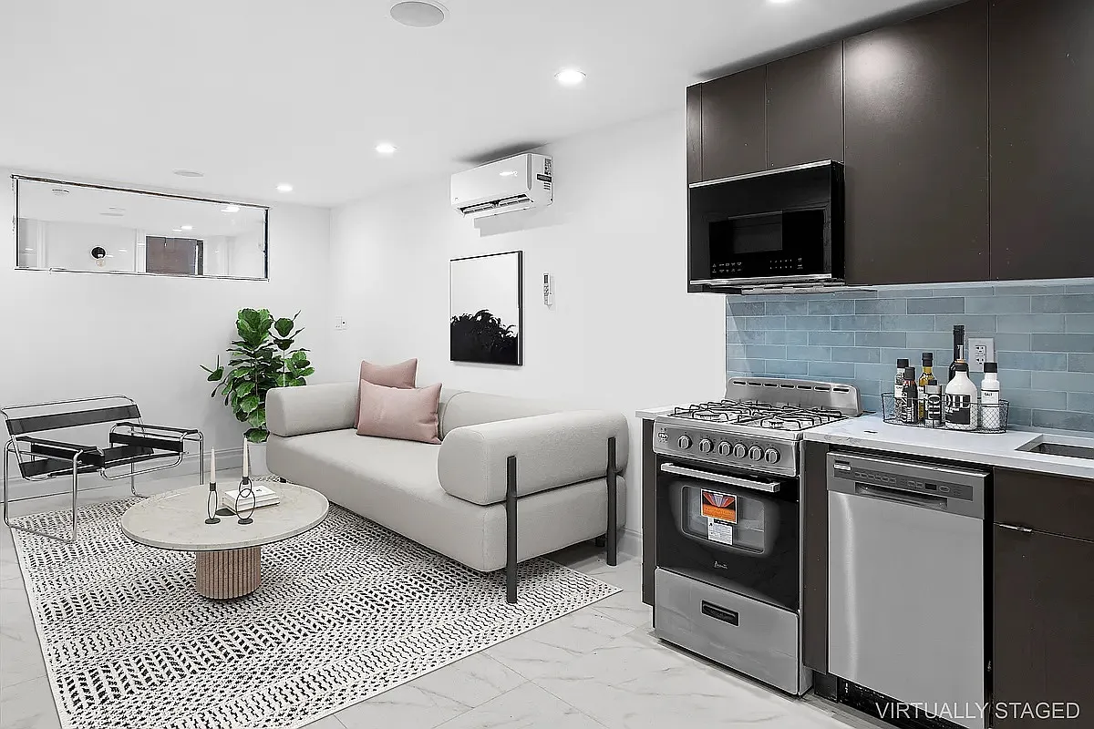 94 Pilling Street, Unit 1 Brooklyn, NY 11207 - Photo 2 of 6 a living room with furniture a flat screen tv and kitchen view