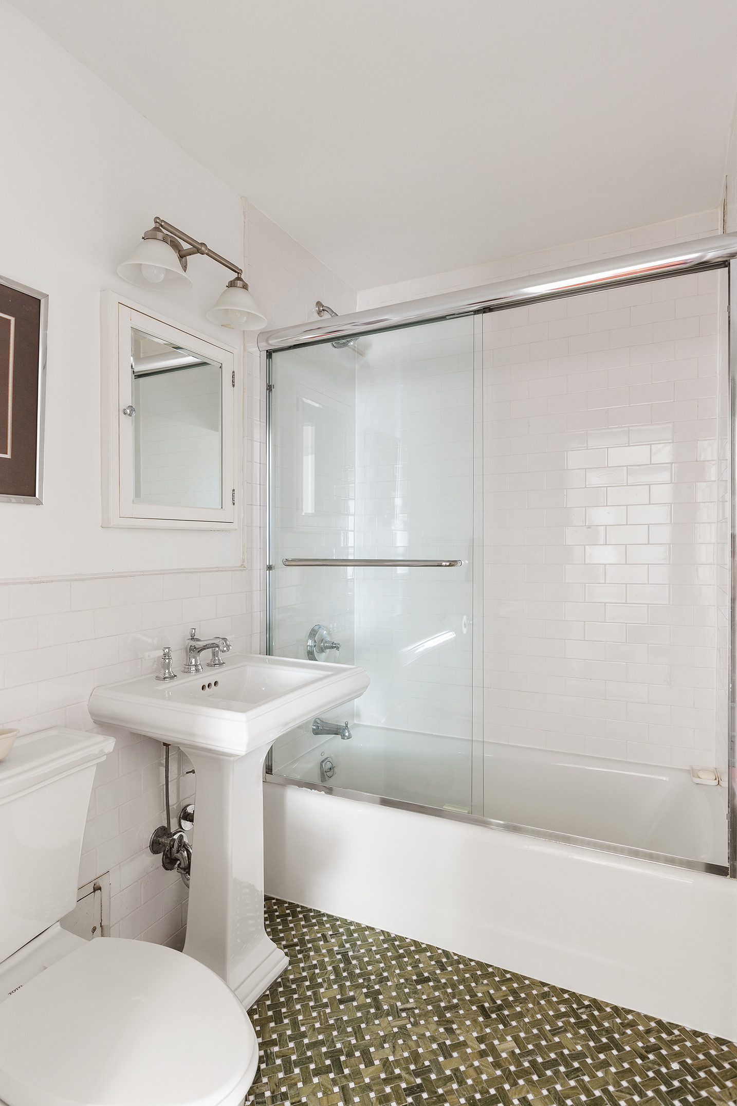 1619 3rd Avenue, Unit 21H Manhattan, NY 10128 - Photo 8 of 16 a bathroom with a sink a toilet a shower and a mirror