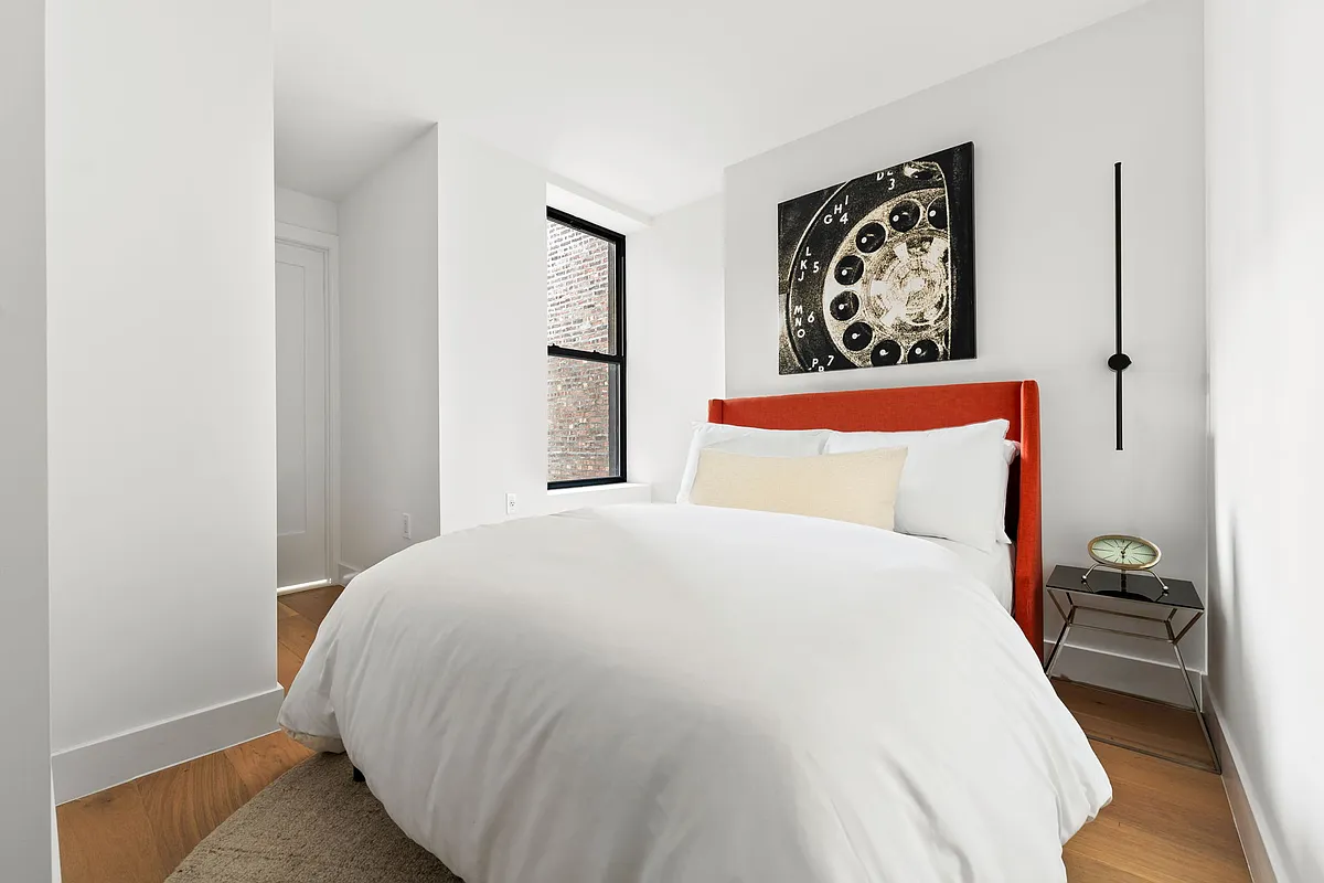 168 Sumpter Street, Unit 2 Brooklyn, NY 11233 - Photo 6 of 10 a bedroom with a bed and a painting on the wall