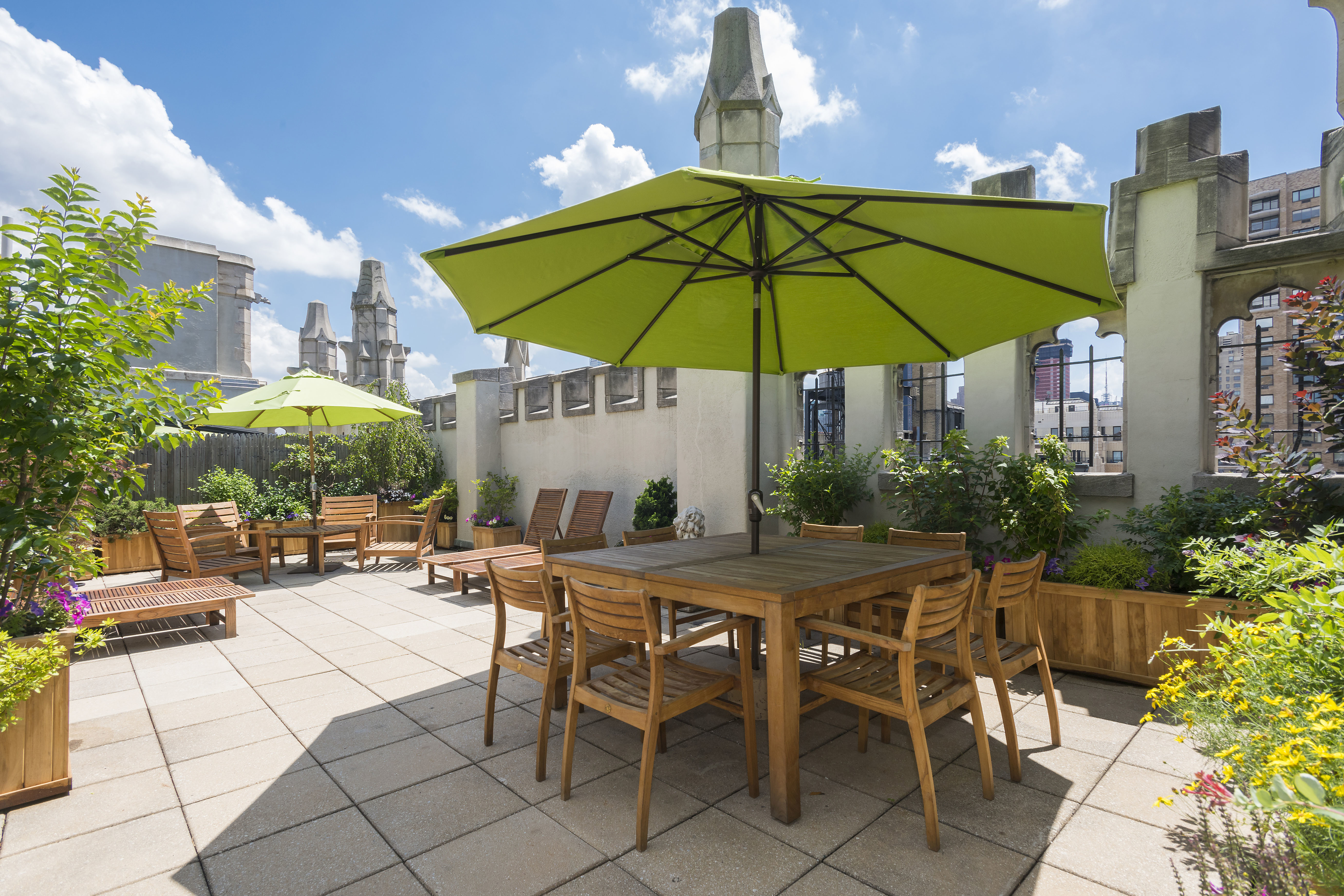 1 West 67th Street, Unit 303-304 Manhattan, NY 10023 - Photo 13 of 18 a view of patio with chairs and table under an umbrella