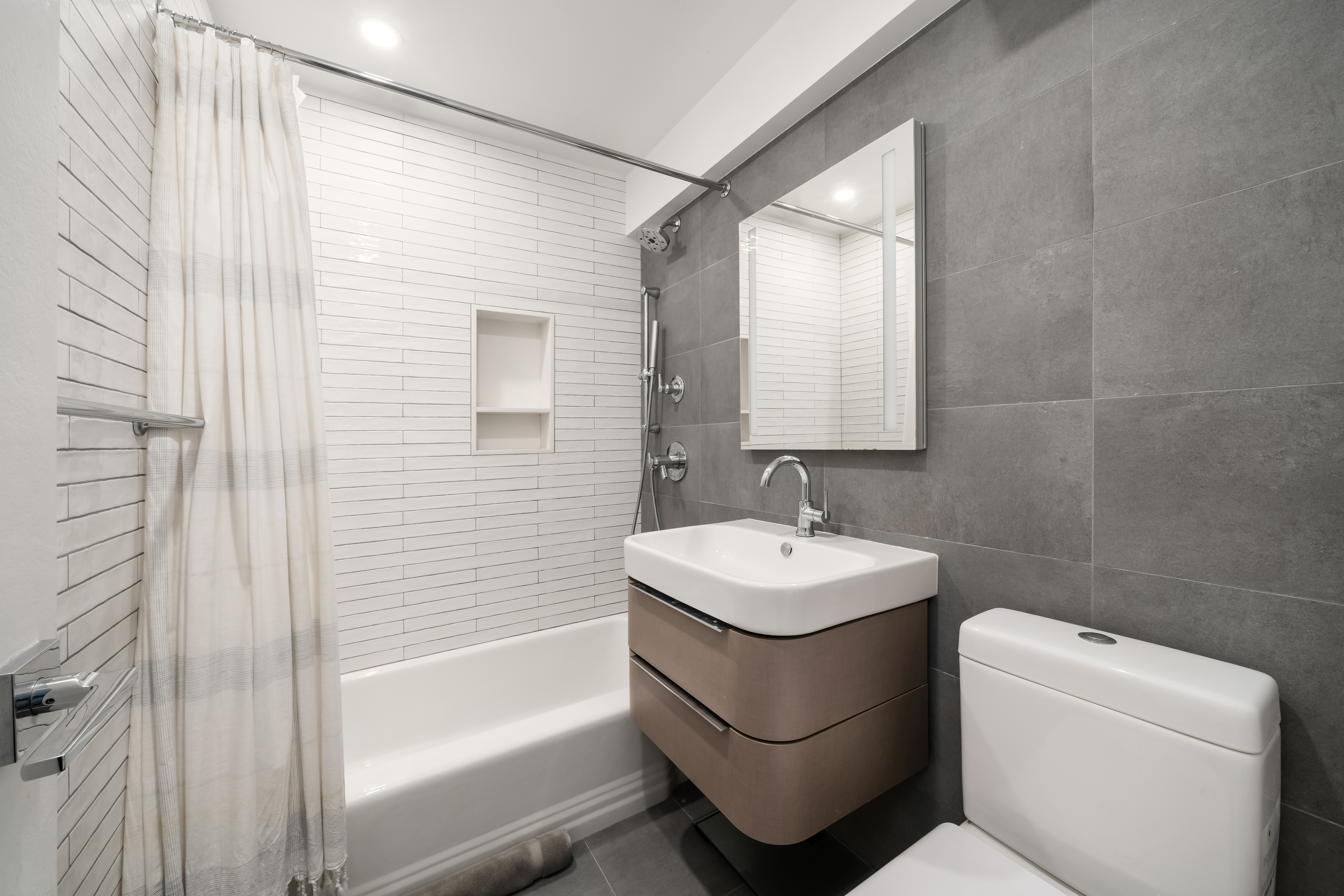 200 East 27th Street, Unit 7EF Manhattan, NY 10016 - Photo 6 of 13 a bathroom with a toilet sink and mirror