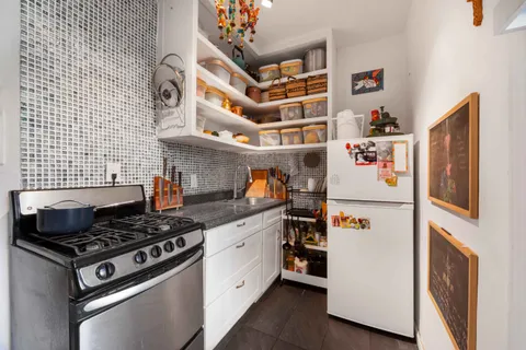 a kitchen with stainless steel appliances granite countertop a stove and a refrigerator