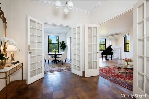 a view of a big room with wooden floor windows and cabinet