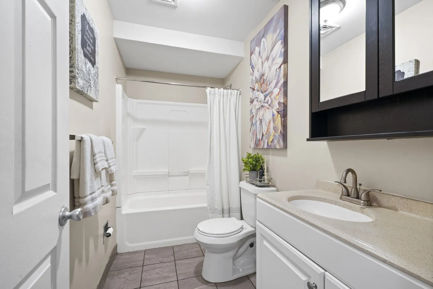 a bathroom with a shower curtain and a sink