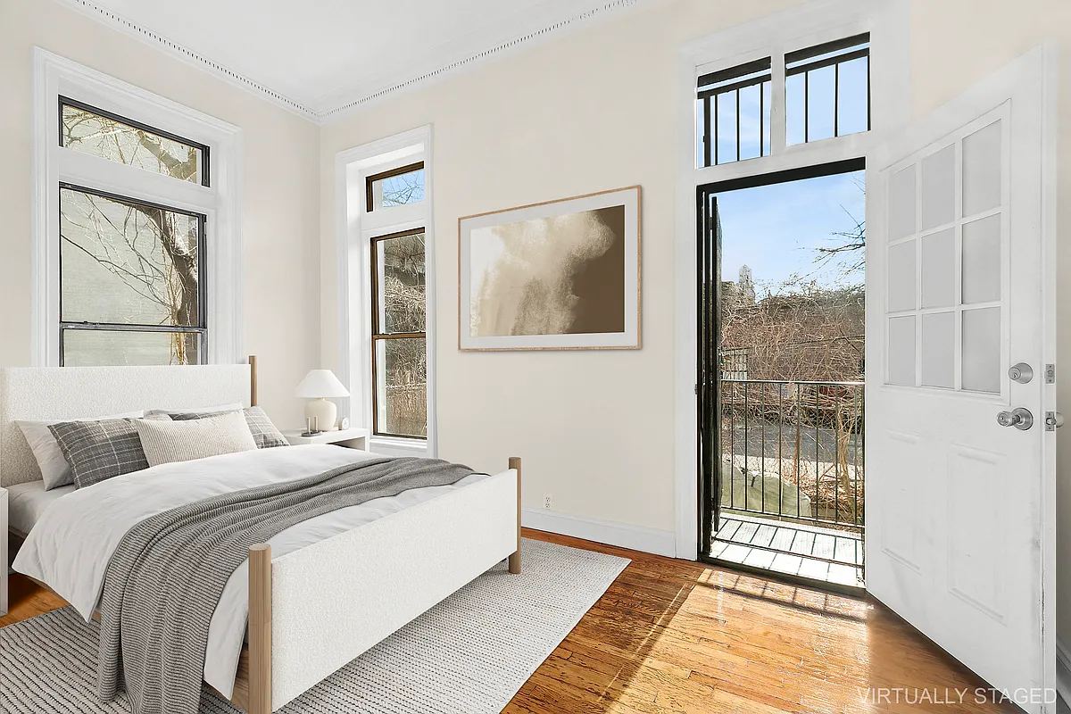 1102 Dean Street, Unit 4 Brooklyn, NY 11216 - Photo 5 of 12 a bedroom with a bed and a painting on the wall